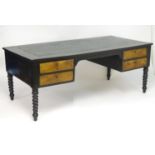 An early 20thC ebonised desk with a rectangular top above four burr walnut fronted drawers, the desk