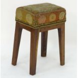 A late 18thC / early 19thC walnut stool with chamfered legs and a rectangular upholstered top with