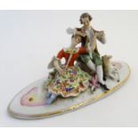 A Continental porcelain oval lid decorated with seated lovers and a lamb, with gilt highlights.