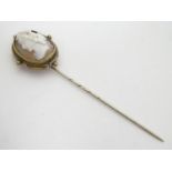 A 19thC gilt metal stick pin surmounted by a Victorian shell carved cameo depicting the head of a