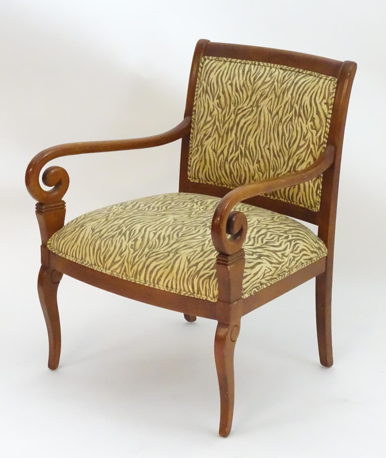 A late 20thC open armchair with upholstered back rest and seat, scrolled arms and raised on cabriole