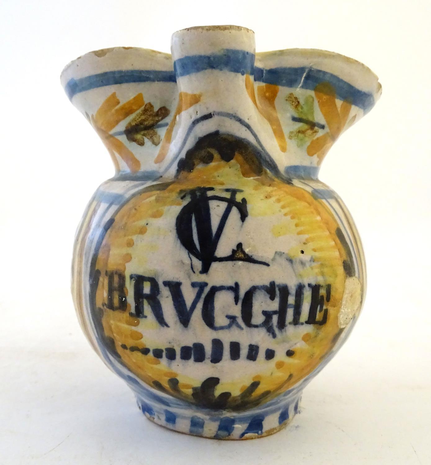 A 19thC Continental faience / tin glaze jug with a pinch spout, decorated with a roundel inscribed