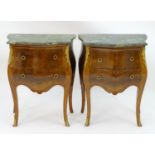 A pair of late 20thC bombe commode style cabinets, with serpentine shaped marble tops above two