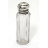 A small glass scent / perfume bottle with silver top hallmarked Birmingham 1918. Approx. 2 1/2" high