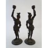 A pair of early-20thC figural candlesticks formed as French 16thC Knights, holding torches aloft