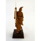 A 20thC figure modeled as an Oriental gentleman wearing robes and a hat. Approx. 7 3/4" overall