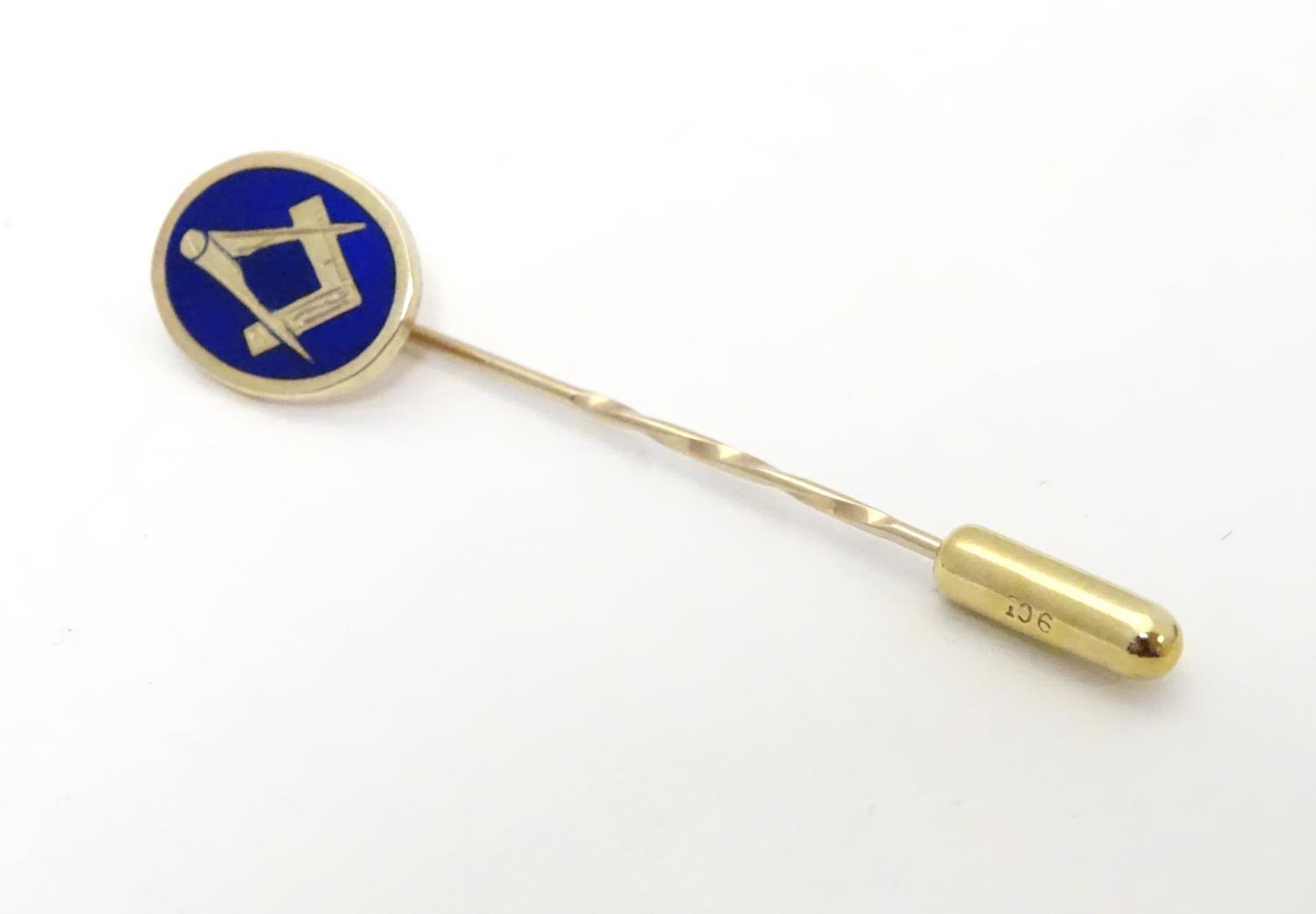 Masonic Interest : A 9ct gold stick pin surmounted by blue enamel oval decoration with masonic