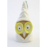 A Royal Worcester figural candle snuffer modelled as an owl wearing a nightcap. Marked within.
