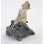 A Royal Copenhagen figure of a faun riding a tortoise, model no. 858, designed by Christian Thomsen.