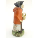 An 18th / 19thC Staffordshire figure modelled as an old lady in a bonnet carrying basket. Approx. 7"