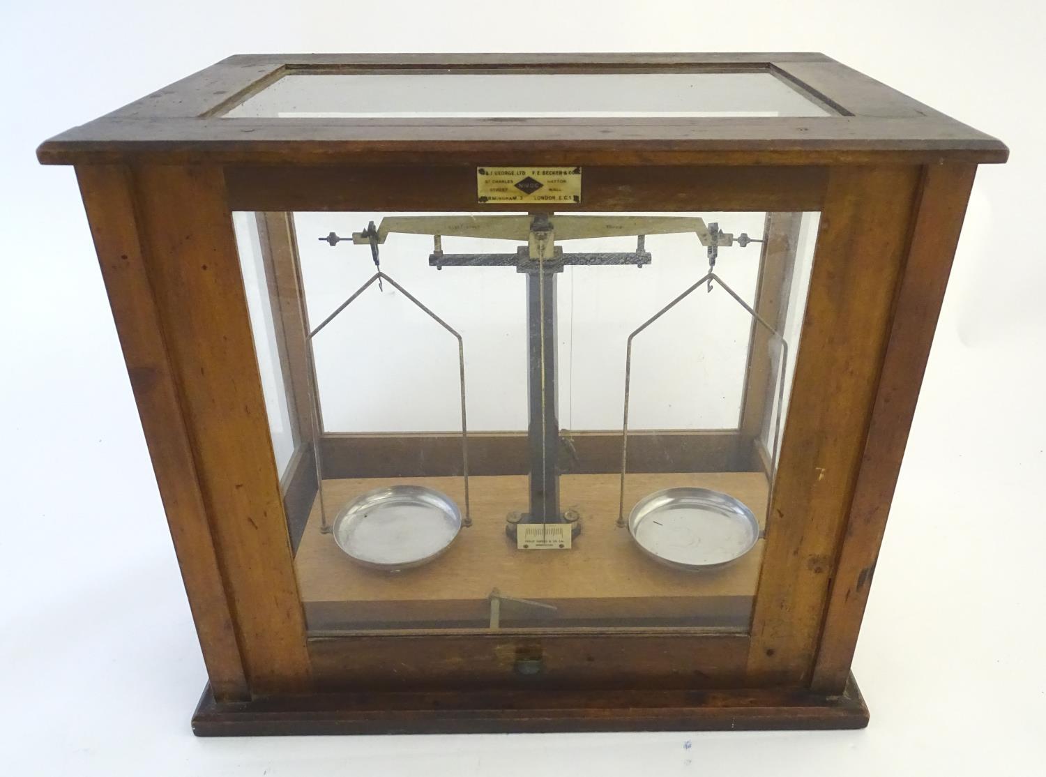 A set of vintage laboratory balance scales by W&J George (Birmingham) and FE Becker & Co (London),