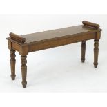 A late 19thC / early 20thC oak hall bench raised on turned tapering legs with gadrooned sections.