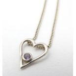 A silver pendant of heart shape set with central amethyst with 18" chain. Please Note - we do not