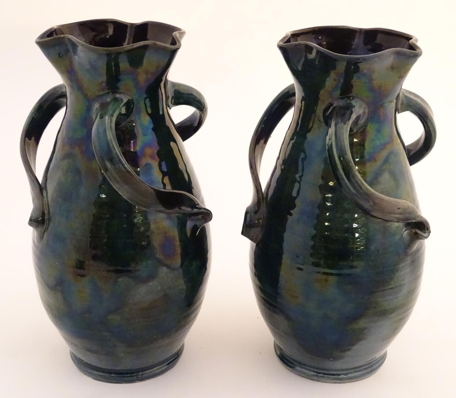 A pair of Baron Barnstaple art nouveau vases in a lustre glaze, with lobed rims and three twisted