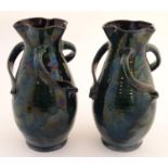 A pair of Baron Barnstaple art nouveau vases in a lustre glaze, with lobed rims and three twisted