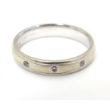 A white gold band set with 3 diamonds. Ring size approx size O. Please Note - we do not make