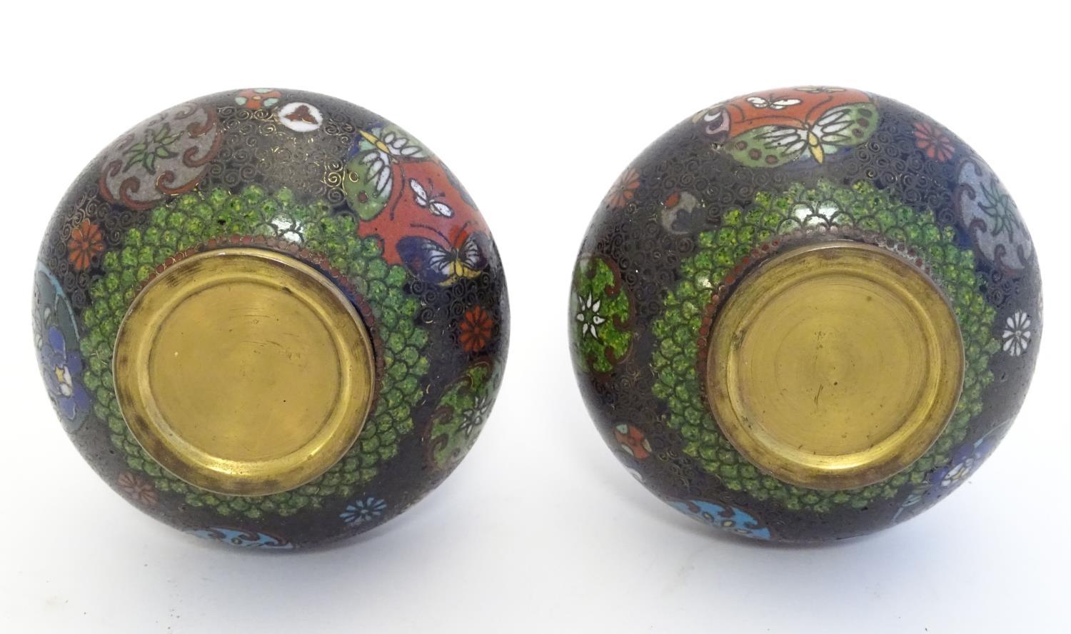 A pair of early 20thC cloisonne bottle vases with elongated necks and flared rims, with floral - Image 8 of 9