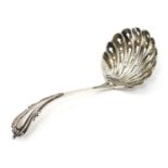 A silver sifting spoon with scallop shell formed bowl, hallmarked Sheffield 1898, maker Cooper