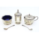 An Art Deco silver three piece cruet set comprising salt, pepper and mustard pot, the salt and