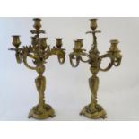 A pair of late 19thC cast brass and gilt candelabra, decorated in the rococco style with heavy