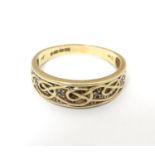 A 9ct gold ring with Celtic style decorationand chip set diamonds. Ring size approx size R 1 1/2