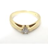 A 9ct gold ring with banded decoration and diamond solitaire. Ring size approx M 1/2 Please Note -