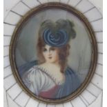 A Continental 20thC oval watercolour portrait miniature depicting a young lady with a flower in