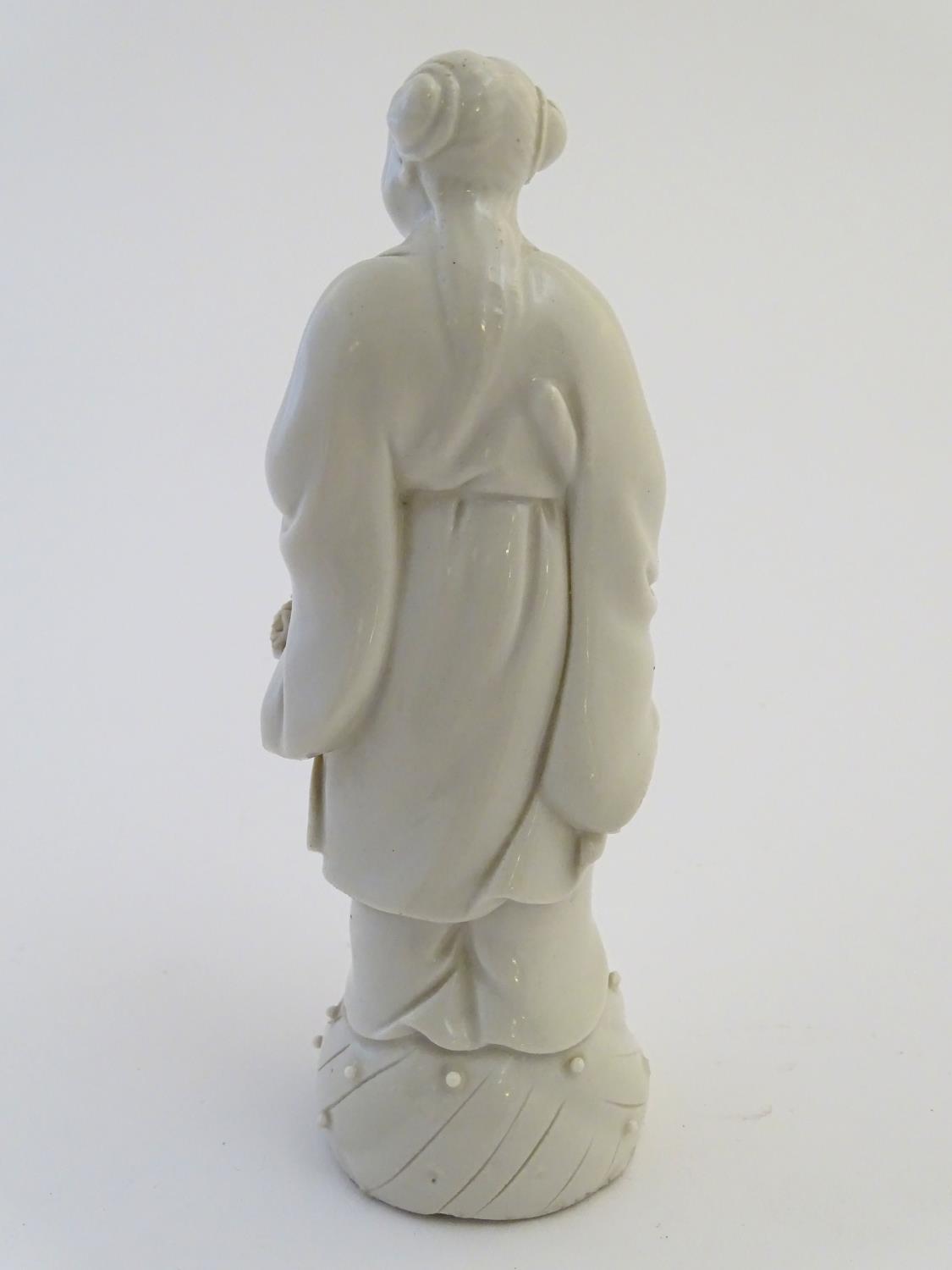 A Chinese blanc de chine depicting the Daoist Immortal figure, Lan Caihe, with a basket of - Image 5 of 9