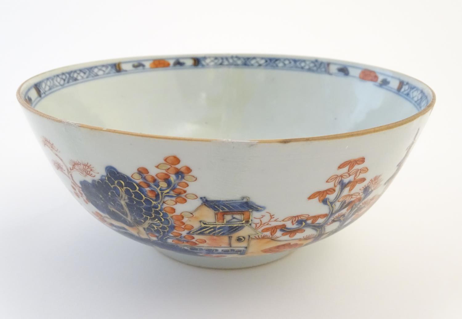 An oriental bowl decorated with landscape scenes and figures in the Imari palette. Approx. 3 1/4"