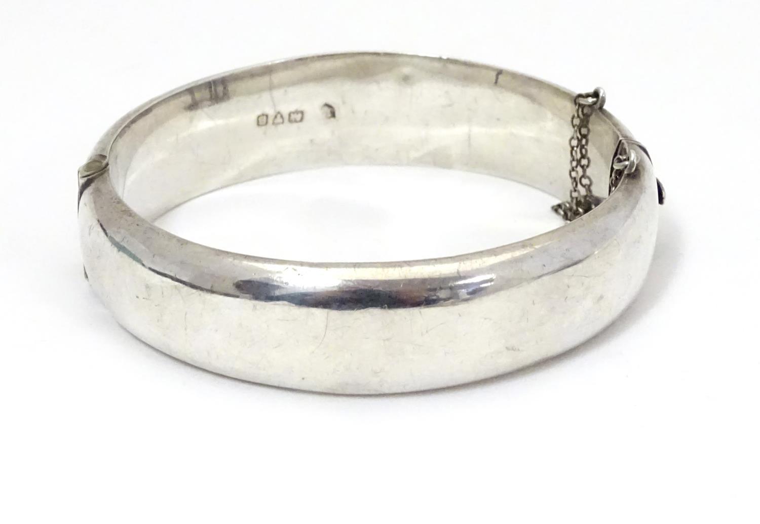 A silver bracelet of bangle form with engraved acanthus scroll decoration. Hallmrked Chester 1952 - Image 2 of 8