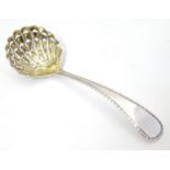 A silver sifter spoon with scallop shell formed bowl, hallmarked Birmingham 1938, maker Barker