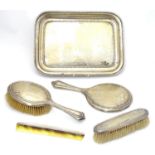 An Art Deco silver dressing table set comprising tray, brushes and com with engine turned