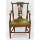 A late 18thC / early 19thC mahogany open arm chair with a shaped top rail, Chippendale back splat