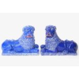 A pair of 19thC faience Luneville lions with a cobalt blue glaze. Depicting recumbent lions on