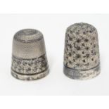 Two silver thimbles, one marked Sterling, the other hallmarked Birmingham 1923 maker James Swann &
