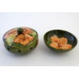 A Moorcroft pot pourri pot and cover in the pattern Hibiscus. Together with a circular dish in the