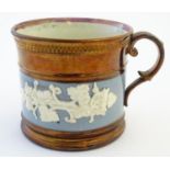 A 19thC copper lustre mug with banded vine decoration in relief and pink lustre rim. Approx. 3 1/