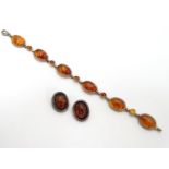 A silver bracelet set with amber cabochons together with a pair of silver clip earrings set with