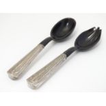 A pair of horn salad servers with Malasian white metal handles having Malay script to end. Approx