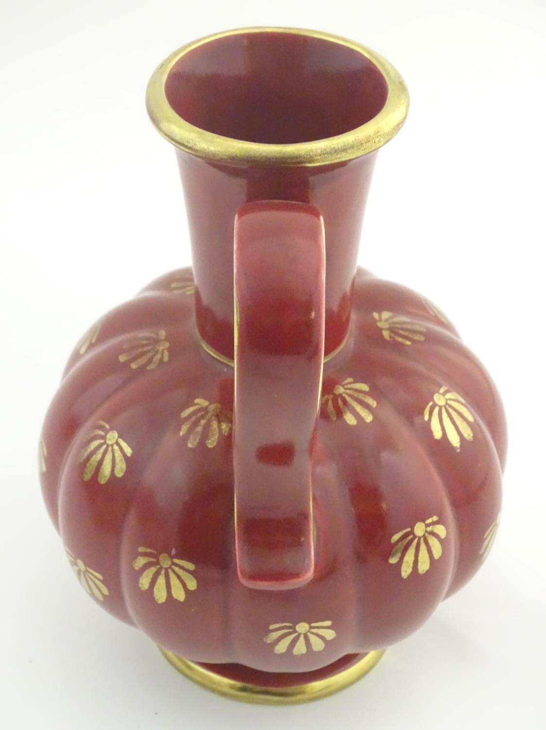 A Swedish single handled vase with a ribbed bulbous body and an elongated neck, with gilt stylised - Image 3 of 7