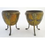 A pair of brass planters / jardinieres with lion mask decoration, raised on three legs terminating