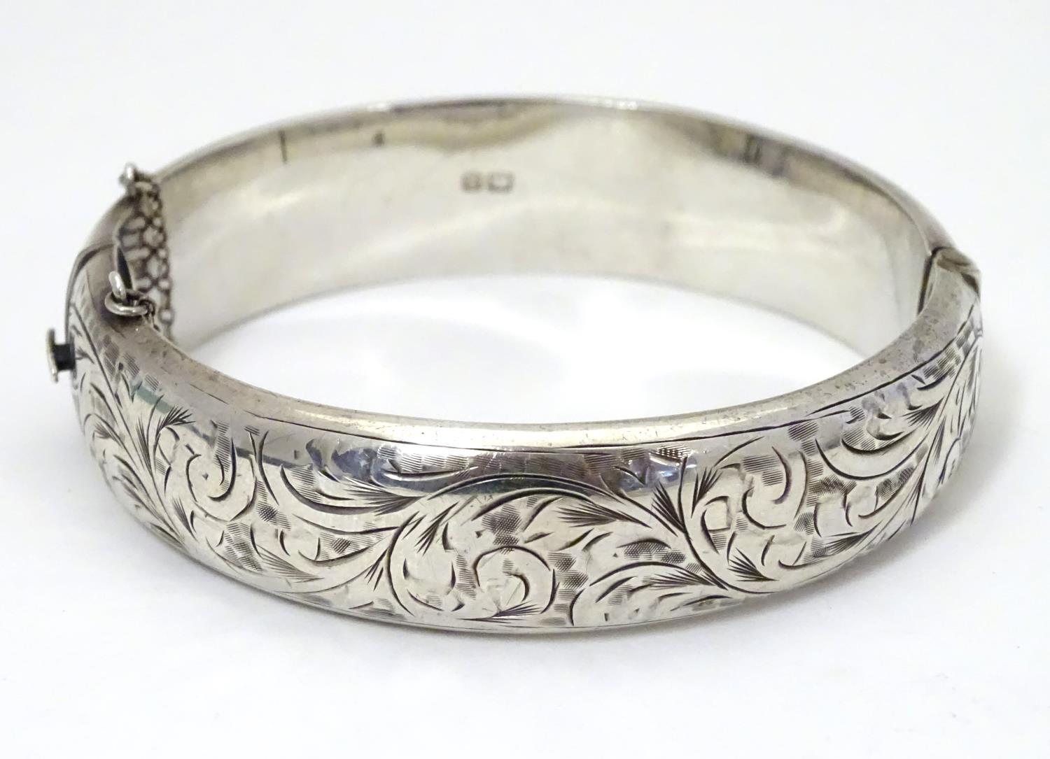 A silver bracelet of bangle form with engraved acanthus scroll decoration. Hallmrked Chester 1952 - Image 3 of 8