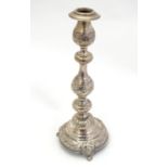 A silver candlestick with floral and fruiting vine decoration. Hallmarked London 1916 maker