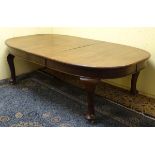 An early 20thC oak dining table with an oval shaped moulded top above large cabriole legs