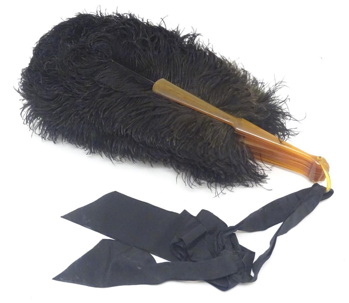 An early 20thC ostrich feather fan, with 18 sticks, the front stick with white metal detail set with - Image 5 of 5