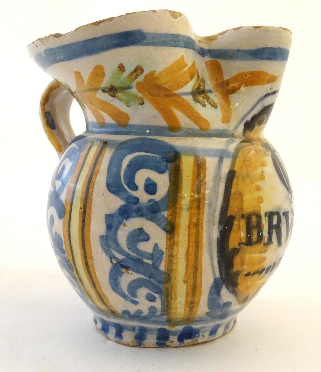 A 19thC Continental faience / tin glaze jug with a pinch spout, decorated with a roundel inscribed - Image 4 of 10
