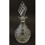 Glass: an early-to-mid 19thC squat decanter, decorated with diamond cuts, the tapering neck with