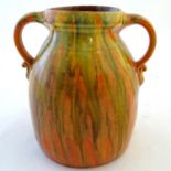 A Brannam of Barnstaple twin handled Barum ware vase with and orange and ochre drip glaze, the