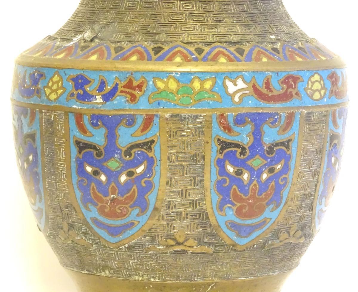 A Japanese brass vase of baluster form with Cloisonné mask and shield decoration to sides. Approx. 9 - Image 4 of 9