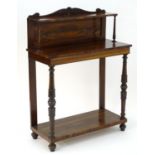 A William IV rosewood console table / pier table with a carved upstand and a raised shelf above